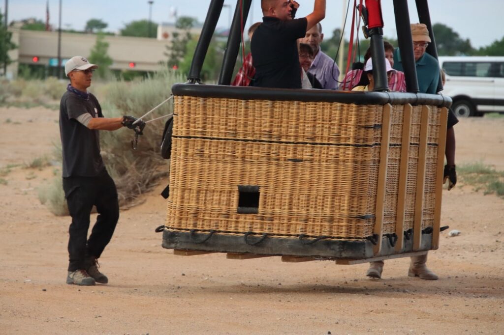 Staff ensuring safety of hot air balloon takeoff