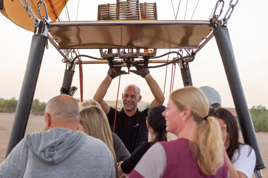 Pilot greeting passengers in a hot air balloon